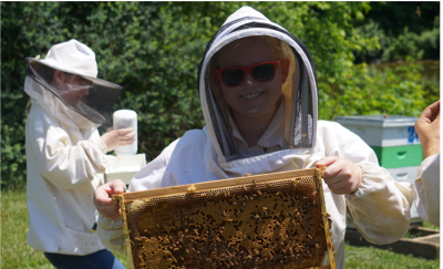 Student holding bee frame